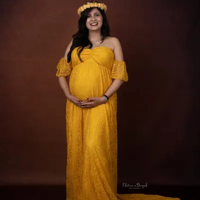 A vision in yellow. This simple, elegant lace gown and floral crown create a beautiful, bohemian-inspired look against a classic brown backdrop.