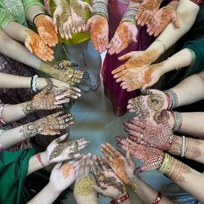 A beautiful circle of hands showing the different mehendi designs for the bride's team. I love creating a unique yet cohesive look for the entire wedding squad.