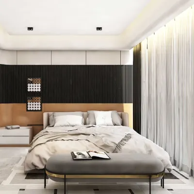 This modern bedroom achieves a refined balance of contrast and calm. A dark, vertically paneled headboard wall provides a textured backdrop for the soft upholstered bed, while a geometric pattern on the floor adds a touch of graphic detail.