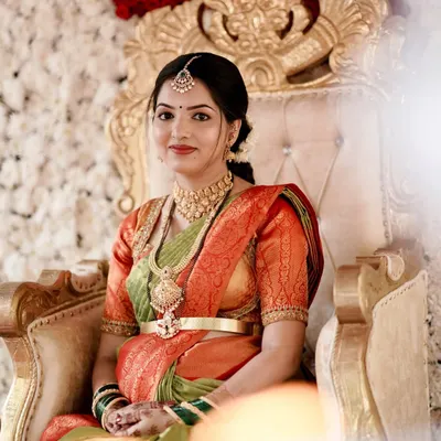 A beautiful mother-to-be at her seemantham ceremony. She is wearing a classic temple jewellery choker and haram set that radiates elegance.