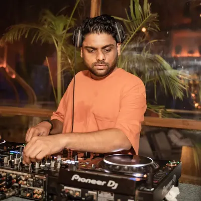 Mixing a deep house set as the sun goes down. The palm trees in the background add to the perfect sundowner atmosphere.