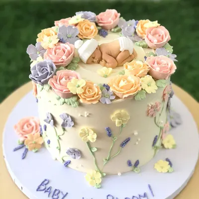 "Baby in Bloom!" This is one of my all-time favorite baby shower cakes, with a sleeping baby nestled in a garden of hand-piped buttercream flowers.