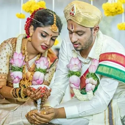 This is a beautiful moment from a traditional Gowda wedding, showing the Dhare ritual. I help my clients plan their weddings to ensure our sacred traditions are perfectly observed.