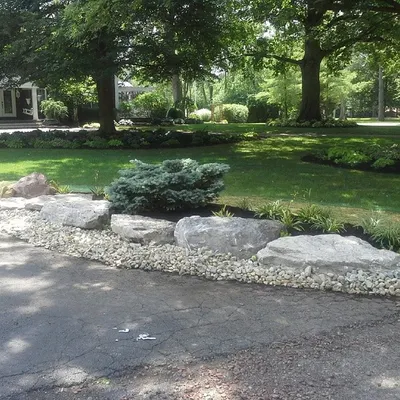 For this driveway, we used large landscape boulders and decorative river rock. This creates a really durable and impressive border that stands out.