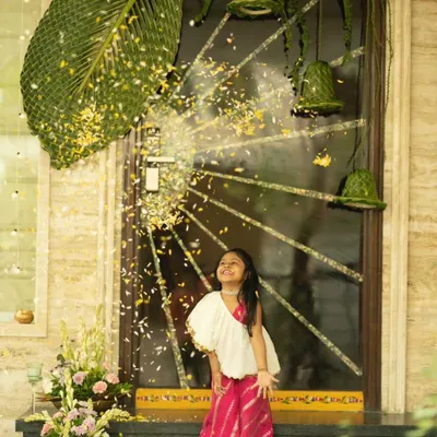 This little girl is having the time of her life in our classic White Rani Jumpsuit. The leheriya print pants and one-shoulder drape make it a stylish yet incredibly comfortable choice for any event.