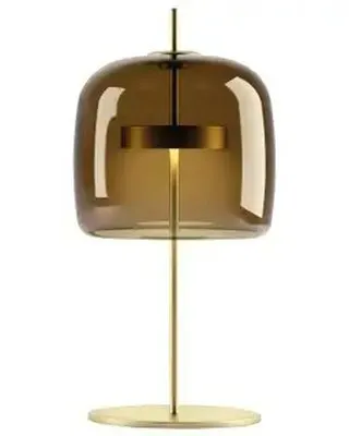 The Jube Vistosi table lamp is a study in elegant simplicity. Its tinted glass shade and slender metal stand create a sophisticated silhouette that provides warm, atmospheric light for a living room or bedroom.