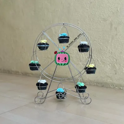 A fun way to display cupcakes at a Cocomelon party is with this cupcake ferris wheel.