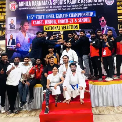 Team UMC celebrating a major victory at the 15th AKSKA State Karate Championship. Holding the team trophy high, this picture captures the spirit of collaboration and the joy of shared success.