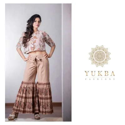 A chic Indo-Western outfit featuring a floral block-printed crop top and belted palazzo pants with pleated details. This look is perfect for a stylish, contemporary festive event.