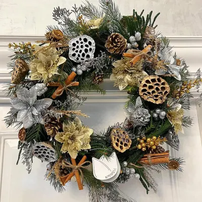 My Moonlit Gilded Wreath is magical, sparkly, and so Christmassy. It features silver and gold foliage, lotus pods, pinecones, and cinnamon sticks for a festive and classy look that will dazzle on any door.
