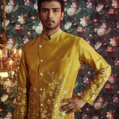 Our ethnic Haldi outfits are crafted from fine silk and feature exquisite hand embroideries, like the delicate floral patterns on this jacket.