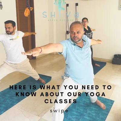 This is what our classes are all about: a community of individuals moving and breathing together. Here, students practice Virabhadrasana II (Warrior II) with focus and determination.