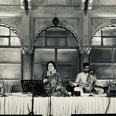 A serene moment from a 'baithaki' style performance, accompanied by a talented musician on the sarangi. The simplicity of this setup allows the nuances of the music to shine.