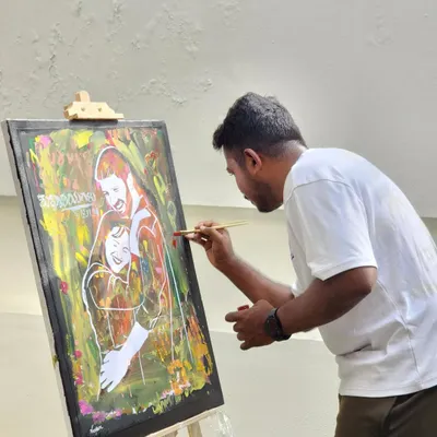 This is a close-up of me at work, focused on adding the fine details to a portrait. Each line is placed with intention to capture the likeness and emotion of the couple.