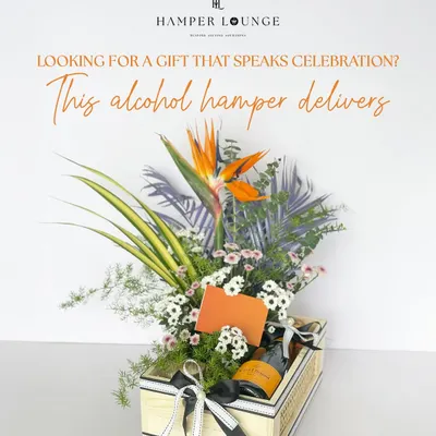 Looking for a gift that speaks celebration? This alcohol hamper delivers. It features a bottle of Veuve Clicquot champagne nestled in a stunning arrangement of tropical flowers and presented in a chic wooden crate.