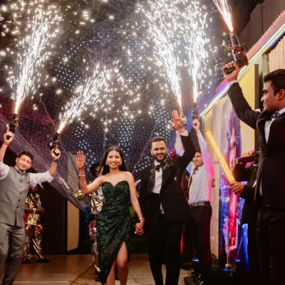 The grand entrance. Shruti and Divyansh make their way into the party through a tunnel of sparklers, a truly cinematic start to an unforgettable night of celebration.