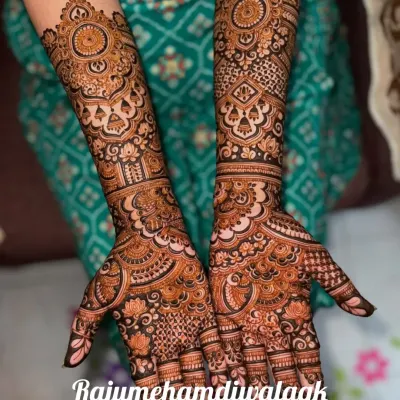 This is a classic full-coverage bridal design. We've used a mix of fine lines, bold floral mandalas, and traditional jaali (net) patterns to create a rich and textured look that extends up the forearm.
