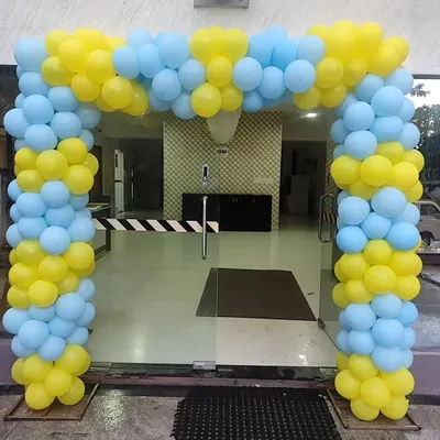 A classic balloon arch in bright yellow and light blue. This type of entrance decor is versatile and can be used for office openings, welcome events, or any cheerful celebration.