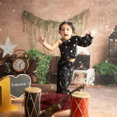 Little Ivaana celebrating her first birthday. This setup, with musical instruments and rustic decor, was designed to match her fun and energetic personality.