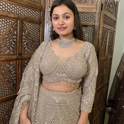 A close-up of this stunning beige lehenga. The intricate sequin work and modern blouse design make it a showstopper.