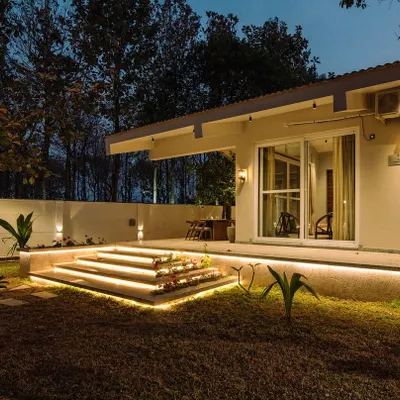 A beautiful night shot of the Amberle farmhouse. The landscape lighting is carefully placed to highlight the architecture and key landscape features without overwhelming the natural, starry sky.