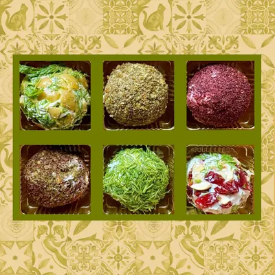 A beautiful box showcasing the variety of my Labneh Balls. Each one is rolled in a different coating, from sumac and za'atar to cashew and cranberry, offering a little ball of flavor for everyone.