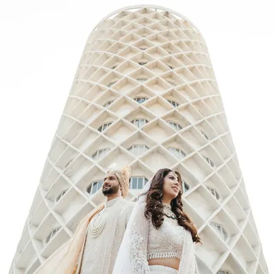 Your love story is a masterpiece, and it deserves a frame that is just as epic. I love finding unique perspectives, like using the stunning architecture of the venue to create a modern, powerful portrait that feels both grand and intimate.
