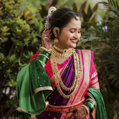 The pure joy of a bride on her wedding day, dressed in a stunning purple and green paithani. I focus on capturing these natural, happy expressions that truly reflect the moment.