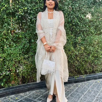 All cream everything. For a wedding, I put together this tone-on-tone look with a slit pant, crop top, and a sheer embroidered jacket.