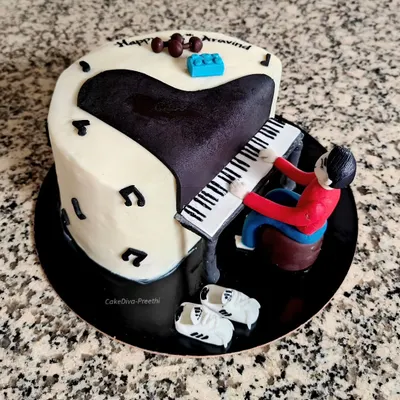A special cake for a piano lover. This design features a hand-sculpted figure playing a grand piano, surrounded by personal touches like fondant dumbbells and Adidas shoes.