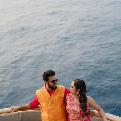 A stunning portrait from a Haldi celebration on the Cordelia Cruise, with the endless blue of the Arabian Sea as the backdrop. A truly unique destination wedding experience.