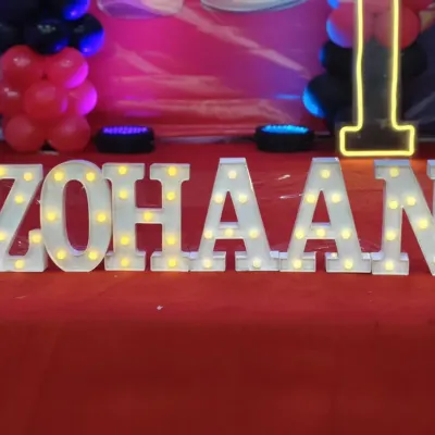 Personalized marquee letters are a fantastic way to make the guest of honor feel special. Here, I provided large, brightly lit letters spelling out the name "ZOHAAN" as a centerpiece for a birthday celebration.