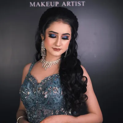 This engagement look is all about drama and elegance. I created a bold blue smokey eye to match her gown, paired with a flawless base and a soft nude lip to balance the look.