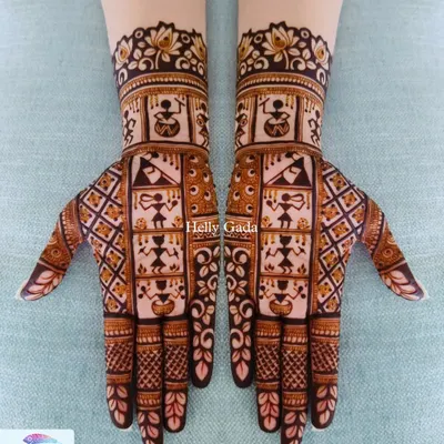 I love incorporating different art forms into my mehndi. This design features traditional Warli art, with its characteristic stick figures depicting scenes of village life, set within a geometric layout.