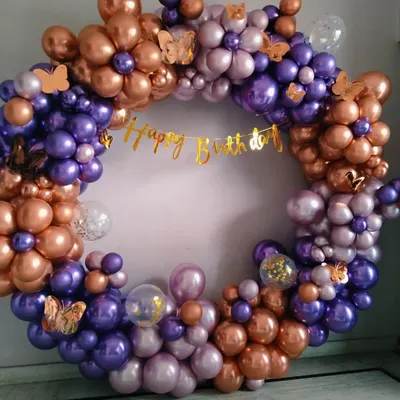 A full and dense circular balloon wreath made of purple and rose gold chrome balloons, perfect as a standalone photo backdrop.