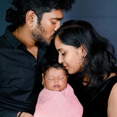 The first family photo. This is such a special moment, with both parents sharing a quiet, loving moment with their newborn. I make sure to capture these connections during every newborn session.