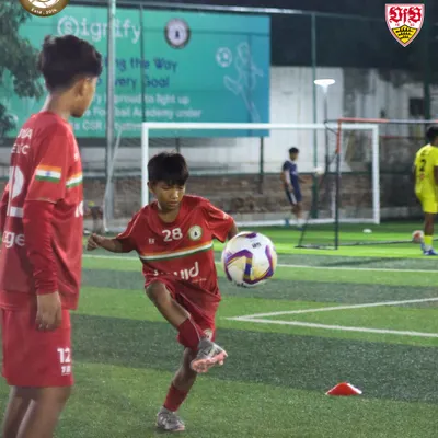A young player in our red kit perfects his first touch. Mastering ball control is the first step towards becoming a great footballer, and we focus on these fundamentals every single day.