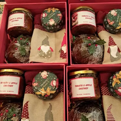 A closer look at the goodies packed inside my Christmas Hampers. You can see the rich, dark Christmas Pudding and the jar of my signature Tomato & Apple Chutney, all ready for gifting.
