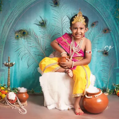 Our little Krishna enjoying his pot of butter. We create detailed and authentic setups for Janmashtami mini-shoots in our studio.