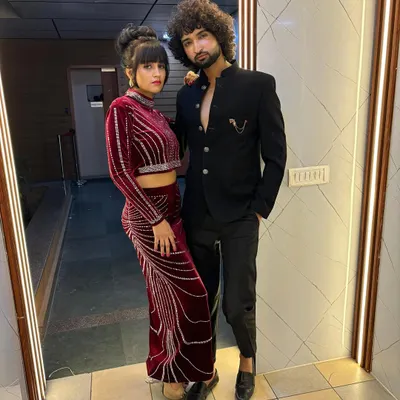 A behind the scenes photo from a perfume branding shoot, featuring models Manisha and Jeet in their coordinating styled looks.