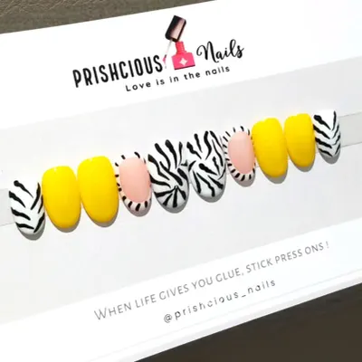 A bold and fun set of custom press-on nails. This design features a mix of bright yellow and a trendy zebra print.
