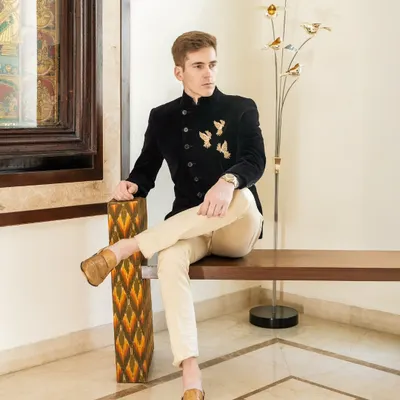 This black velvet Angrakha-style bandhgala is one of my signature pieces. The antique gold embroidered flying birds add a touch of poetic elegance, making it a perfect outfit for a cocktail evening or reception.