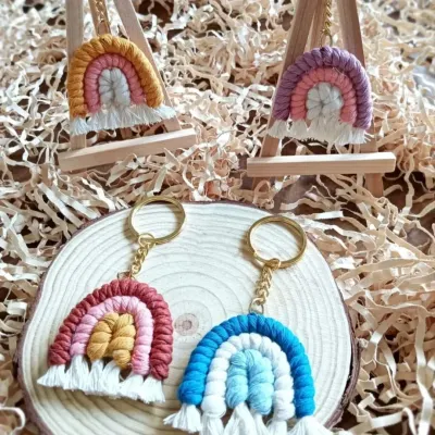 My macrame rainbow keychains are perfect for return gifts and gift hampers. Here they are displayed on mini easels, showing off their vibrant colors and cute, fringed clouds.