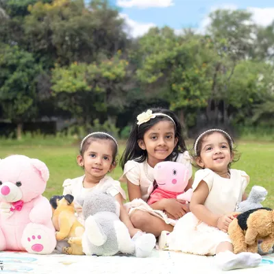 Three times the laughter, three times the love. An outdoor picnic with teddy bears makes for a fun and adorable photoshoot for these sweet sisters.