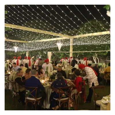 An enchanting outdoor sit-down feast under a canopy of fairy lights. We manage every detail to create a magical ambience for large-scale wedding receptions.