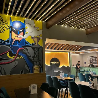Our standout feature is the massive Batman-themed mural, a perfect photo opportunity and a symbol of the unique, modern vibe we cultivate. It’s a centerpiece of our cafe's artistic ambiance.