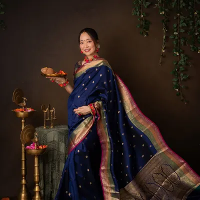 A modern goddess. Draped in a stunning blue silk saree, this mother-to-be holds a traditional plate of offerings. This is a beautiful fusion of cultural ritual and maternity celebration.