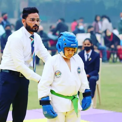 Coaching one of my students from the sidelines during a sparring match. My role is to guide them, keep them focused, and help them adapt their strategy in real-time.