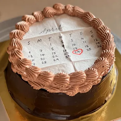 This is a "burn away" cake, one of our best sellers. This design features a calendar marking a special date, and the top layer burns away to reveal a hidden message or image underneath.