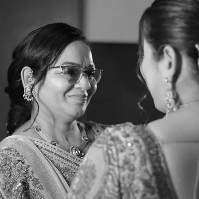 A mother's love, a lifetime in a glance. This over-the-shoulder shot captures the pride and emotion in a mother's eyes as she looks at her daughter, the bride.